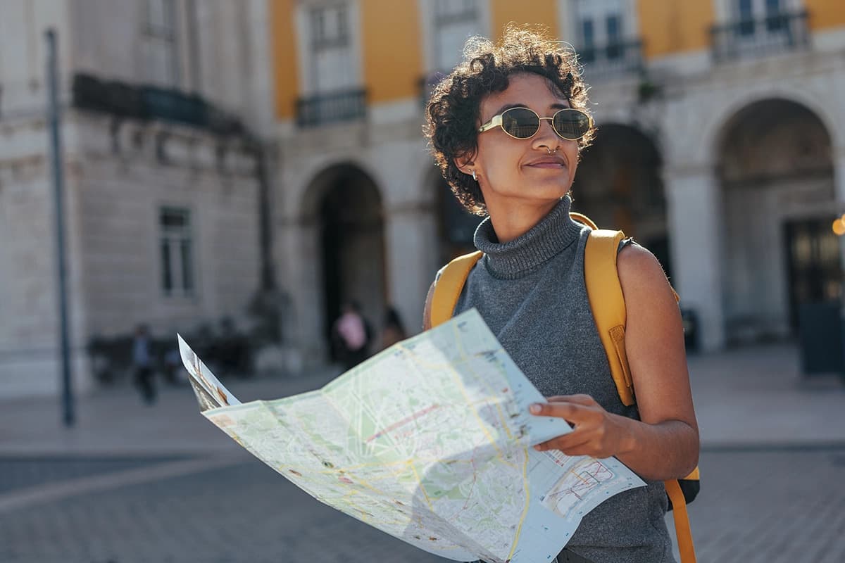 A traveller reading a map in a sunny city square